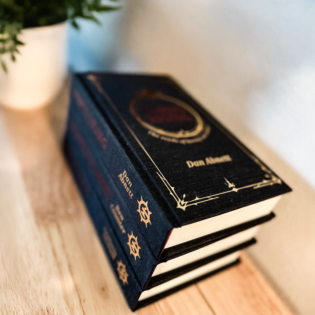 Stack of books with a decorative cover on a wooden surface