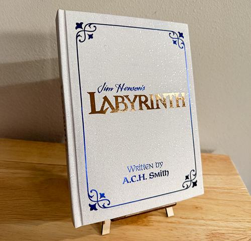 Book titled 'Labyrinth' by A.C.H. Smith on a wooden stand against a neutral background